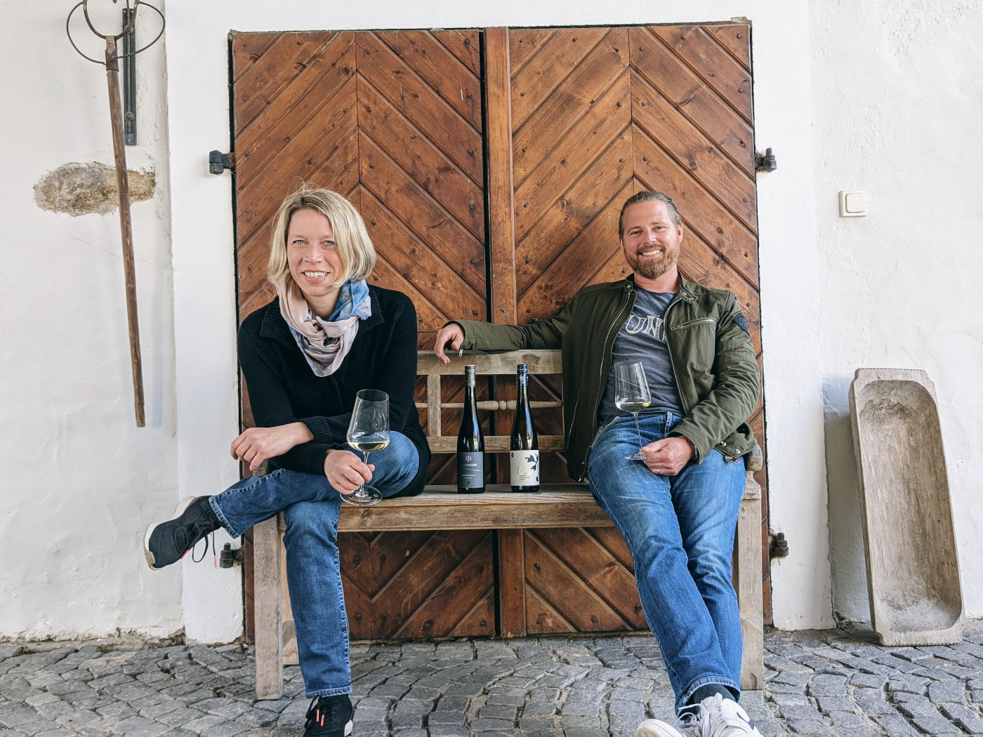 Silke Mayr and Urban Stargad sitting in front of a door